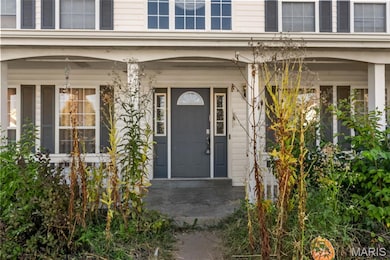 View of exterior entry with covered porch