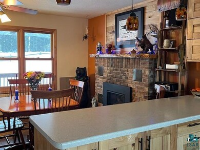 Kitchen featuring hanging light fixtures, a textured ceiling, and a fireplace
