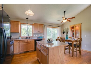 Kitchen has wood floors and center island.