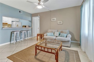 Tiled living room featuring ceiling fan