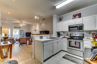 Kitchen featuring stainless steel appliances, a si