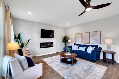 Living area featuring dark wood-style flooring, ba