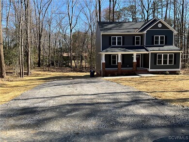 View of front of property with a porch and drivewa