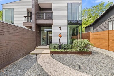 View of exterior entry featuring fence and a balc