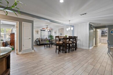 Dining space featuring built in shelves, crown mol