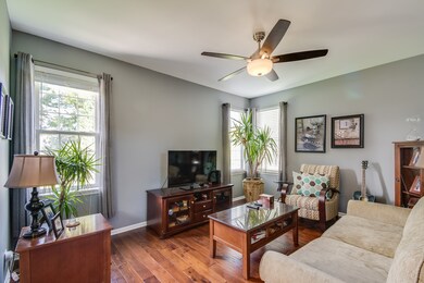 Corner windows, hardwood floors, gray paint with w