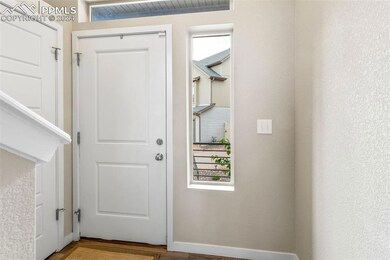 Doorway to outside featuring hardwood / wood-style