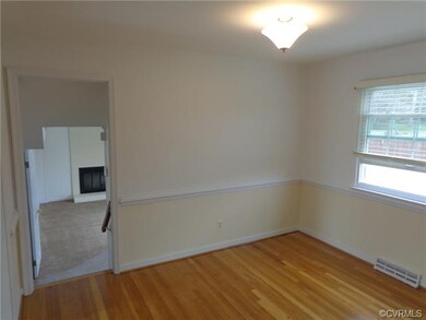 Dining room with chair rail, oak floors and lookin