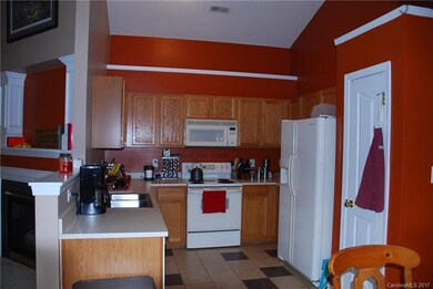 Kitchen with tiled flooring and pantry.