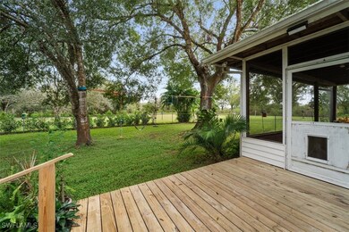 Wooden terrace featuring a lawn
