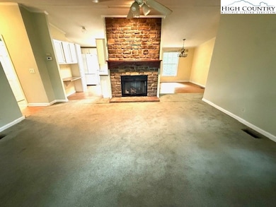 Living room offers a floor-to-ceiling gas log fireplace.