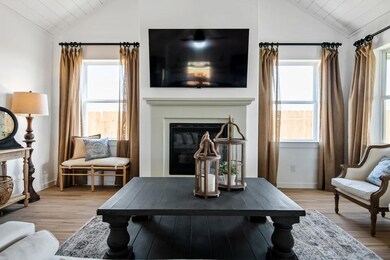 Great room with vaulted ceiling and white-painted ceiling beams