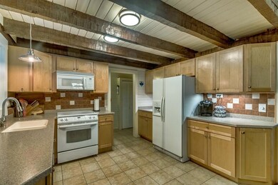 Tile back splash accentuates the efficient kitchen