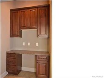 Near the kitchen, the mom's desk could be used as 