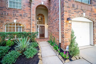The entry has an elegant lead glass front door with fresh landscaping  to greet your guests.