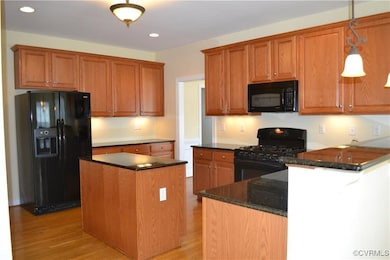 Kitchen featuring brown cabinets, recessed lightin