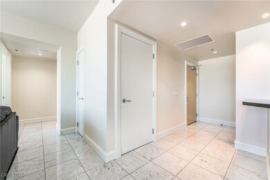 Hallway with baseboards, visible vents, and recess