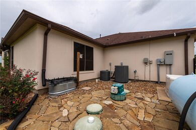Rear view of house featuring stucco siding, a pati