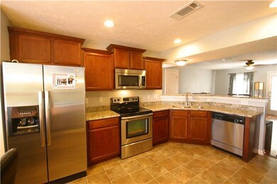 Kitchen w/ hardwoods, Stainless, Granite Counters and Custom Cabinets with added space. Faucets and Hardware are upgraded too.