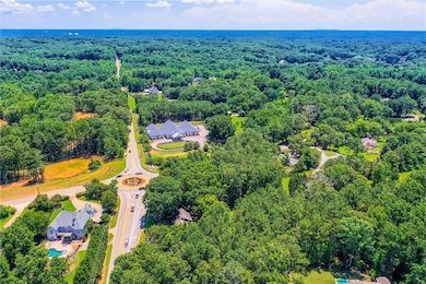 Aerial view of property and surrounding area featuring a forest and property parcel outlined