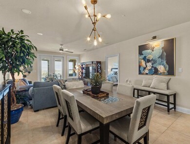 Dining area with light tile patterned flooring, a ceiling fan, and baseboards