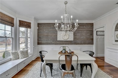 Dining area with an inviting chandelier, wood fini