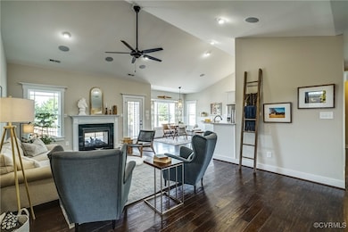 Living room featuring dark wood-type flooring, a m