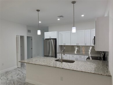 Kitchen with stainless steel appliances, a sink, a