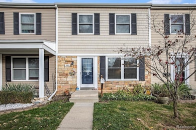View of front of home featuring stone siding and a front yard
