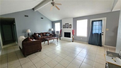 Large living space with fireplace and tall ceiling