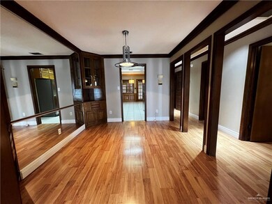 Unfurnished dining area with ornamental molding and light wood-style flooring