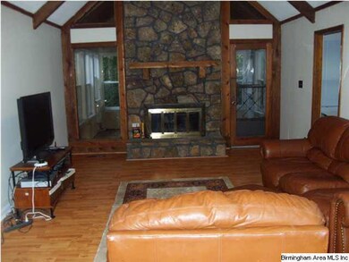 STONE FIREPLACE IN LIVING ROOM.