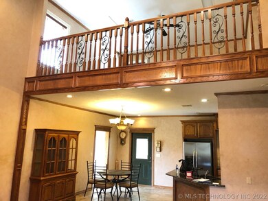 VIEW OF LOFT BEDROOM AND OPEN KITCHEN