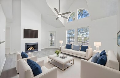 The Living area showcases LUXURY VINYL PLANK FLOORING, vaulted ceilings, and large windows, including a beautiful ARCHED FEATURE WINDOW that fills the home with sunshine. Virtually Staged.