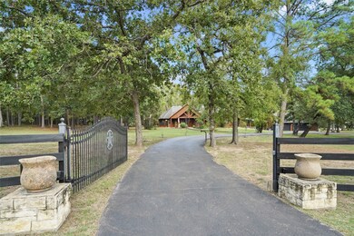 As you approach the automatic gate to this log home on 5 beautiful acres there is a feeling of tranquility. The gate is made of sturdy wrought iron and provides both privacy and security. As you enter, you are greeted by a winding driveway lined with scattered hardwoods. So please come visit and experience the beauty of this stunning property.