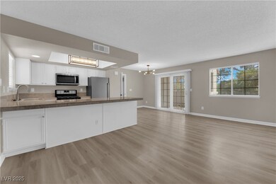Kitchen featuring a chandelier, stainless steel ap