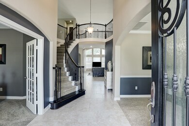 The wrought iron front doors open to the two-story foyer.  The dedicated study is to the left, formal dining to the right.