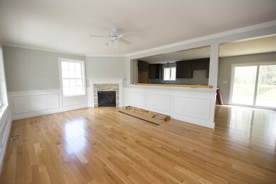 Beautiful wood work surrounds this living room wit