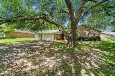 Single story home featuring a garage and a front y
