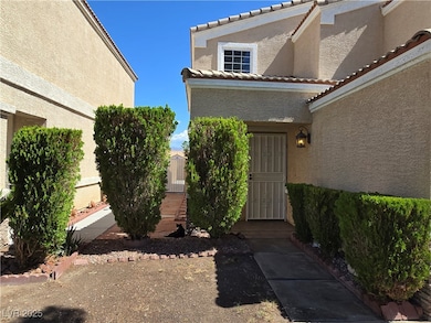 View of exterior entry with stucco siding and a ti