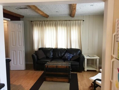 Repainted living room with exposed beams