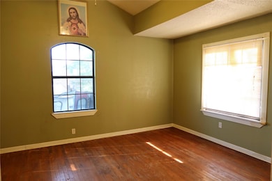 Empty room with dark wood-type flooring