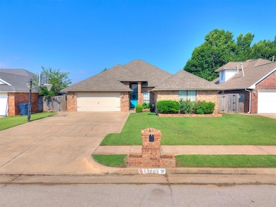 View of front of home with brick siding, a garage, driveway, and a shingled roof