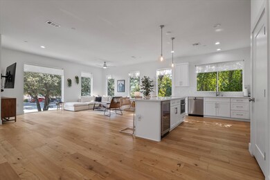 As you step into the second-floor living space, the abundance of soft natural light instantly sets the tone with windows on two sides. The open-concept layout feels bright a