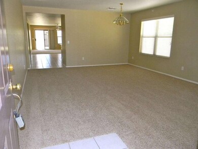 Entrance into living/chandeliered dining
