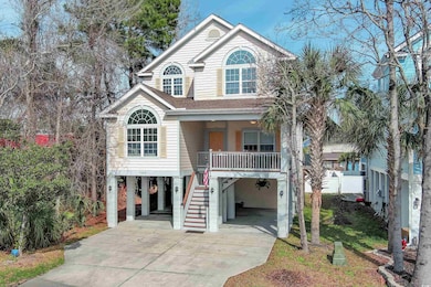 Coastal inspired home with a carport and a porch