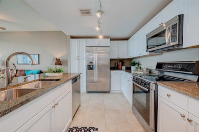 Modern kitchen with sleek granite countertops, sta