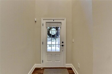Entryway featuring baseboards and dark wood-type f