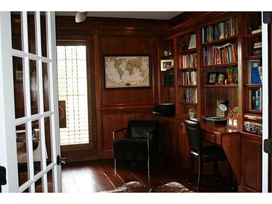 Den. Paneled den with bookcases and access to side