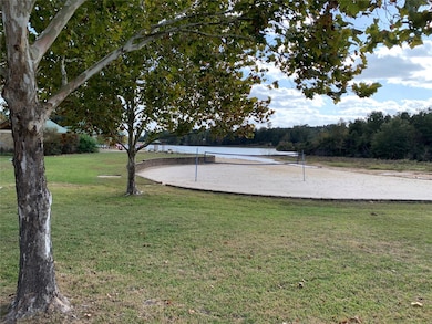 View of property's community with volleyball court and a yard